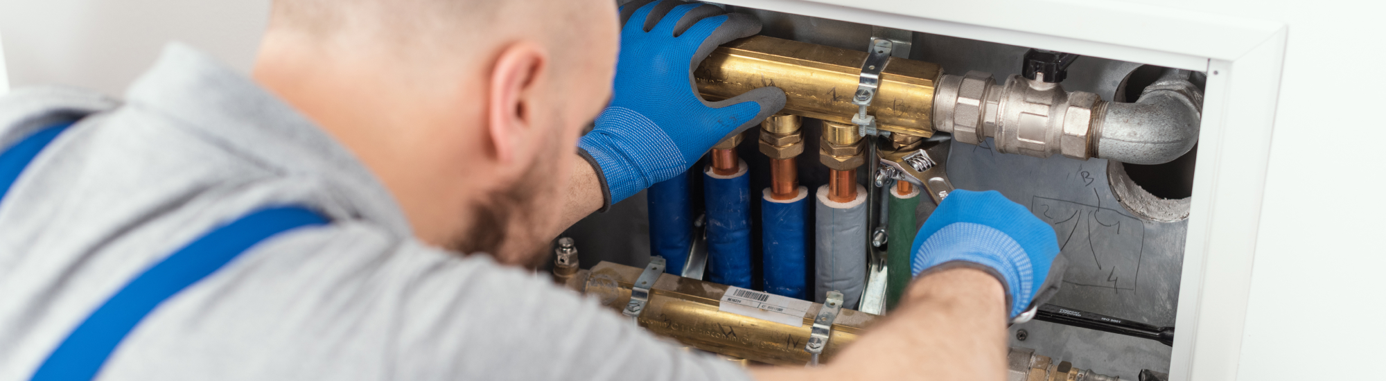 Worker installs valve during inspection