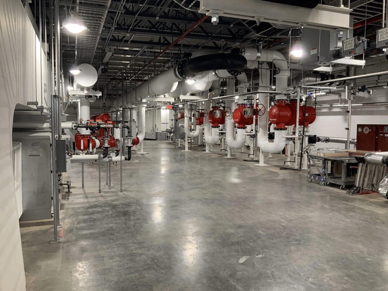 Pipping System within building featuring red and white pipes
